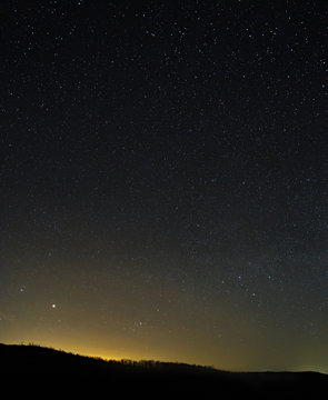 The stars in the night sky. A view of the starry space background sunset illuminated the horizon.