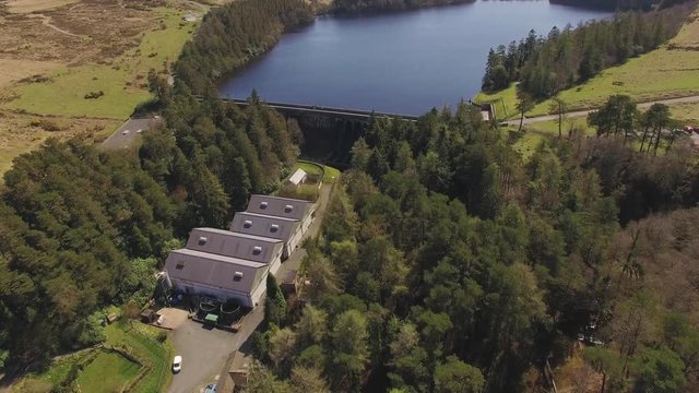 Aerial Drone Footage of Reservoir & Dam Surrounded by Trees & Moorland, UK Countryside