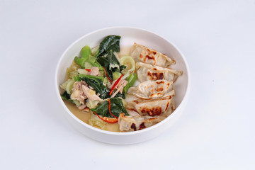 Steamed stuffing flour topped Chinese kale and streamed streaky pork in soup with sliced chili .