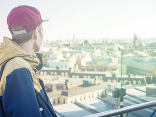 young man in the city wathcing at panorama view, shot from the back