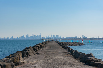 Long pier, jetty with modern cityscape on the background