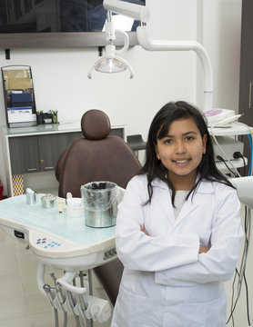 Child girl doctor posing in a dentist office.