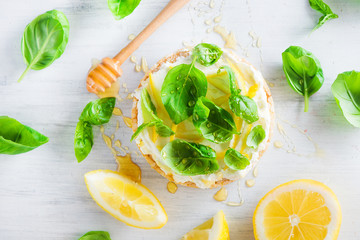 Healthy snack with crisp bread, lemon zest, honey and basil. Easy appetizer recipe.