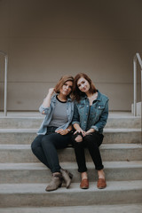 Beautiful Female Friends Hanging Out on Outdoor Concrete Stairs