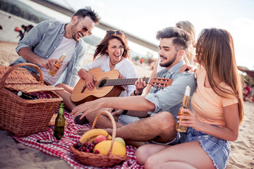 Happy young people having fun at beach party