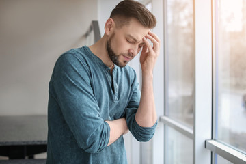 Man suffering from headache at home