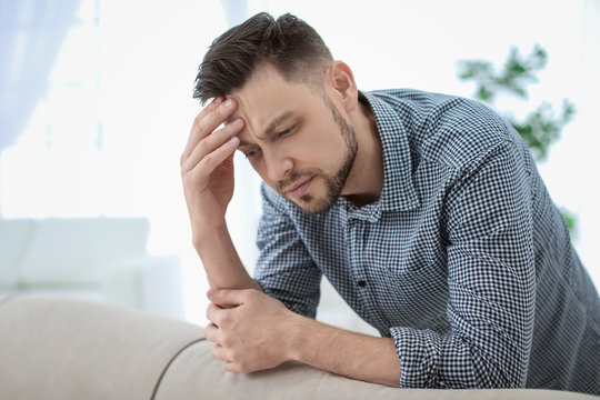 Man suffering from headache at home