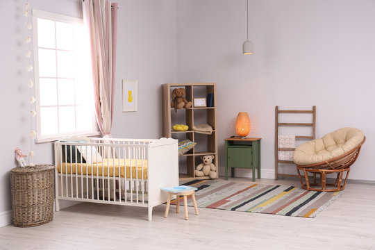 Baby room interior with comfortable crib and papasan chair