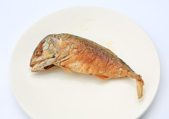 Fried mackerel on white plate.