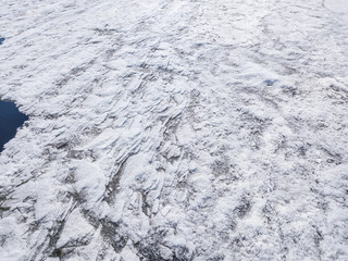 Aerial view of the ice texture broken into pieces of different shapes and sizes 
