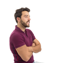 Man in profile looks to the side. Beautiful and bearded person. He is wearing a magenta polo shirt.