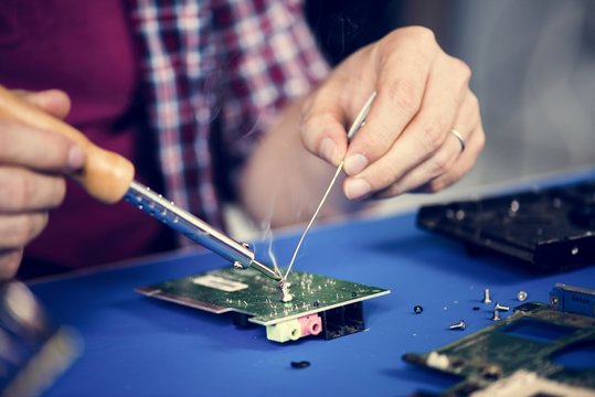 Closeup of tin soldering with electronics circuit board