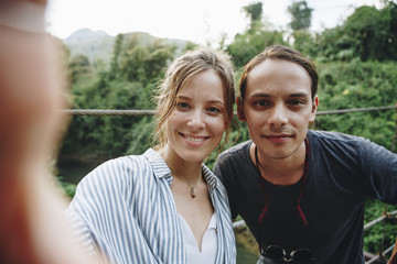 Caucasian woman and man taking a selfie outdoors recreational leisure, freedom and adventure concept