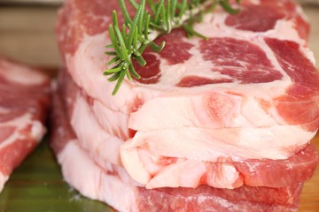 Raw pork steaks with salt and pepper