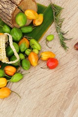 chilli peppers for cooking on wood background