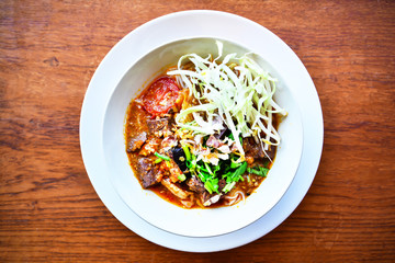 Northern Thai noodle soup on wood table background