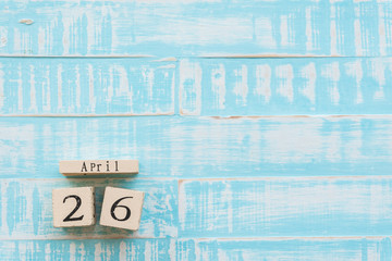 World Intellectual Property Day April 26, Wooden Block calendar on blue Pastel wooden table background texture.