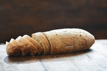 Sliced loaf fresh bread wooden table view straight