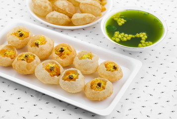 Indian Street Food Pani Puri Also Know as Golgappa or Golgappe is a Common Street Snack From India. It Consists of a Round, Hollow Puri Filled With a Mixture of Flavoured Water And Other Chat Items.