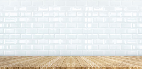Wood plank table top at white glossy ceramic tile wall background,Mock up for display or montage of product,Banner or header for advertise on social media