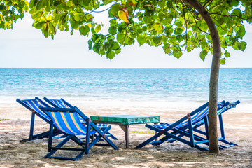 folding chair with blue color on the beach in sunlight with sea view/Nature and a holidays