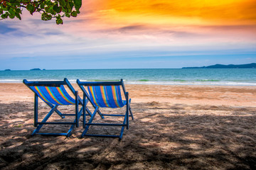 folding chair with blue color on the beach in sunlight with sea view/Nature and a holidays