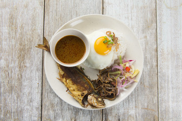 fried fish with rice with spices and curry flat lay