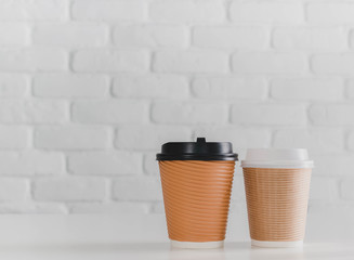 Two coffee cup on white brick wall background - Mock up can used for display or montage your products.