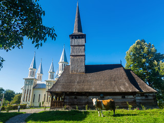 Fototapeta na wymiar Old and new church in Remetea Chioarului , Romania