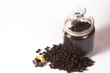 Coffee beans in a jar on old kitchen table.