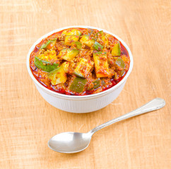 Indian Traditional Raw Mango Pickle Also Know as Aam Ka Achar or Kari Ka Achar on Wooden Background