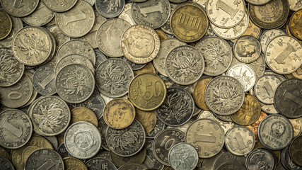 Abstract Background Of Pile Of Coins, Including US dollar, Euro, Chinese RMB, Turkisk, Mexican, Malaysian, Thai and Swedish Money.