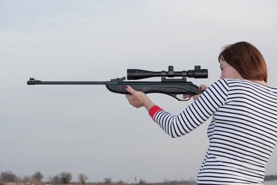 Portrait of middle aged woman with rifle