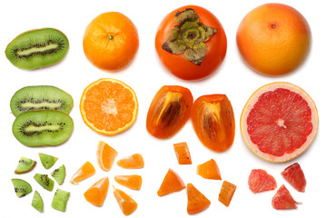 healthy food. mix sliced persimmon, orange, mandarin, kiwi fruit and grapefruit with green leaf isolated on white background. top view