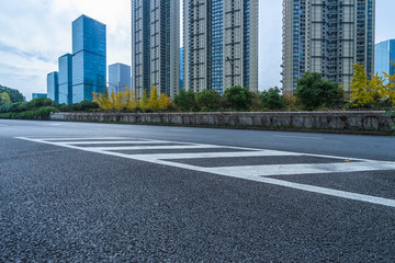 city empty traffic road with cityscape in background.