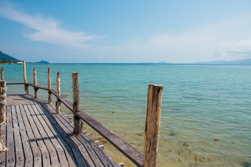Fototapeta na wymiar Paradise beach with wooden bridge