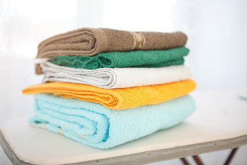 Four stacked,pastel colors Bath Towels