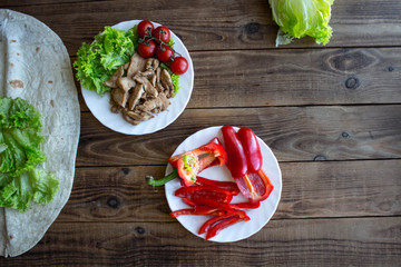 pita grilled meat tomatoes pepper on a plate and salad on wooden background