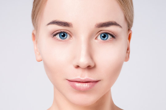 Woman beautiful face portrait. Beauty Portrait. Beautiful Spa model Girl with Perfect Fresh Clean Skin. Blonde female looking at camera. Youth and Skin Care Concept.