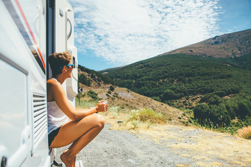 Girl sits on a motor home step - 201981737