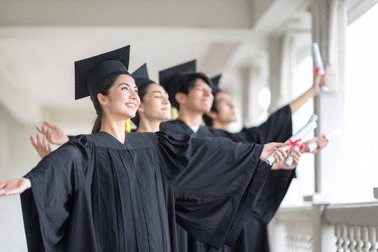 Graduation day, Images of Happily graduates are celebrating graduation, A certificate in hand, Happiness feeling, Commencement day, Congratulation. Education Concept.