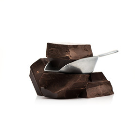 Chocolate in a metal scoop on a white background