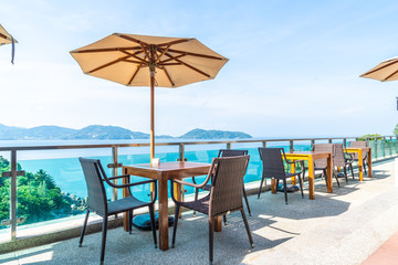 Beautiful umbrella and chair around swimming pool in hotel and resort - vacation concept