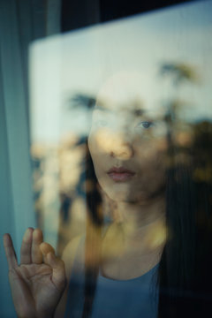 Woman behind a glass window.