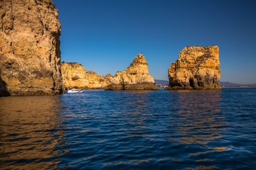 Fototapeta na wymiar Lagos Caves and Seashore with its Esmerald Water. Exposure done in a boat tour in the Lagos seashore, Algarve, Portugal
