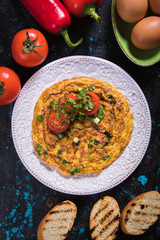 Omelet, fried chicken eggs with fresh vegetables