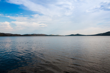 Lake and white clouds under lake in a sunny day