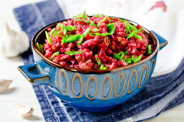 Buckwheat stewed with beetroot in a bowl on a wooden table