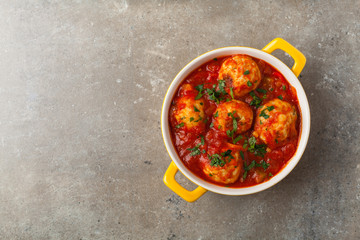 Chicken meatballs with tomato sauce. Served with rice.