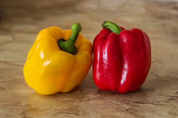 Red and yellow pepper on stone background